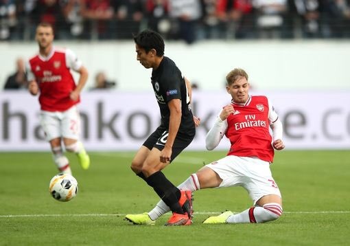 Emile Smith Rowe of Arsenal tackles Makoto Hasebe